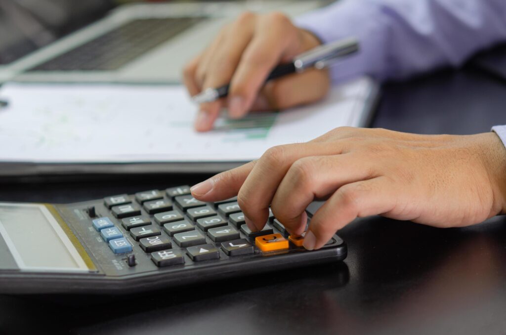 businessman hand pressing a calculator Business, finance, tax and investment concept. 3582871 Stock Photo at Vecteezy